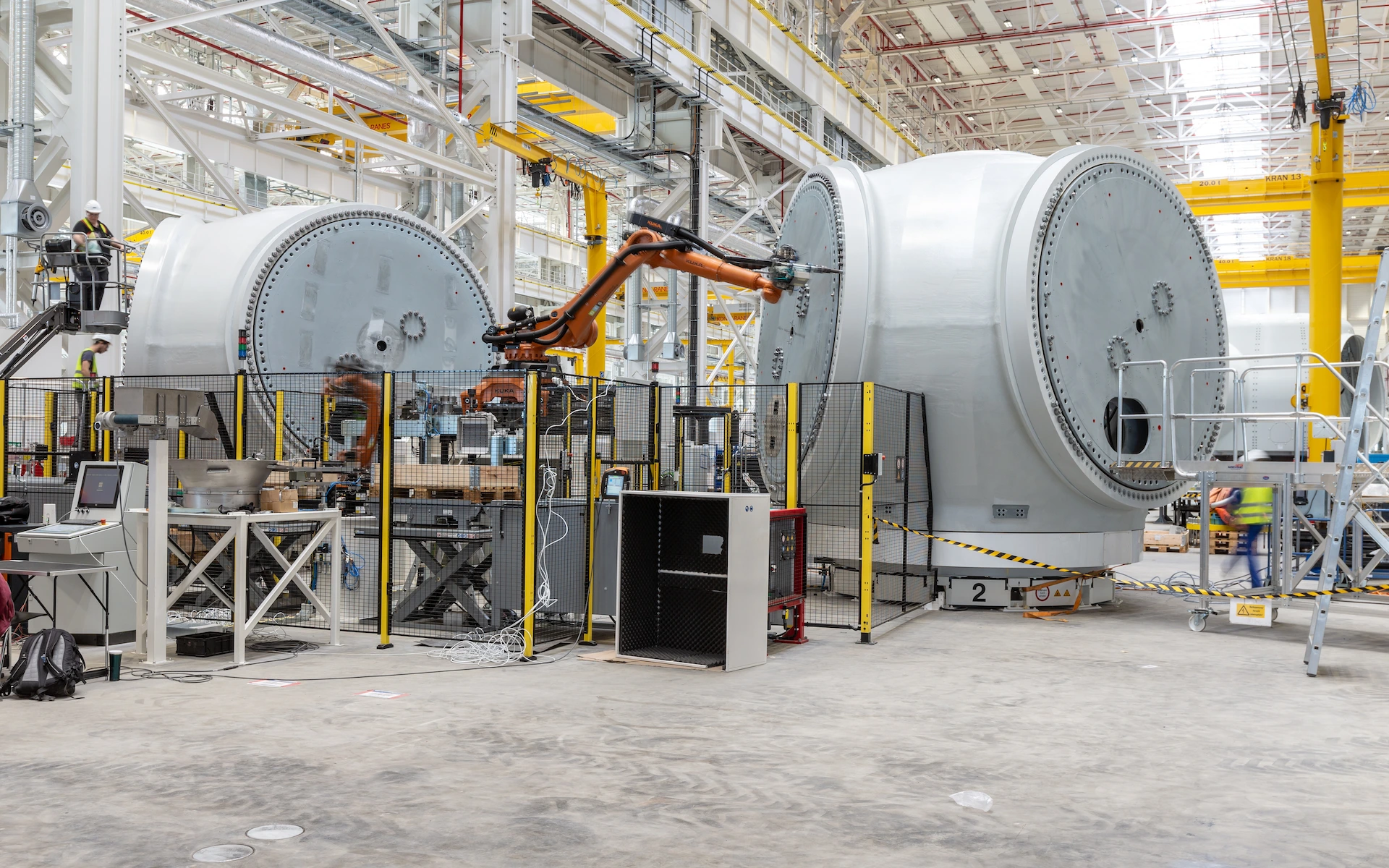 Neubau Siemens Windturbinen Fabrik in Cuxhaven als Innenraumaufnahme mit Roboter-Fertigung, Krananlage in zwei Ebenen und großen Windanlagen-Spinnern.